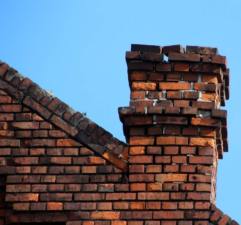 Damaged chimney on an Coronado home showing cracks and missing mortar